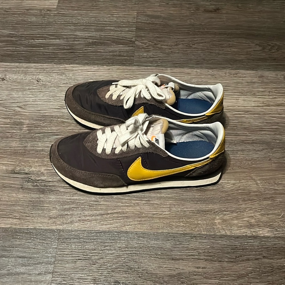 Brown and yellow Nike running shoes